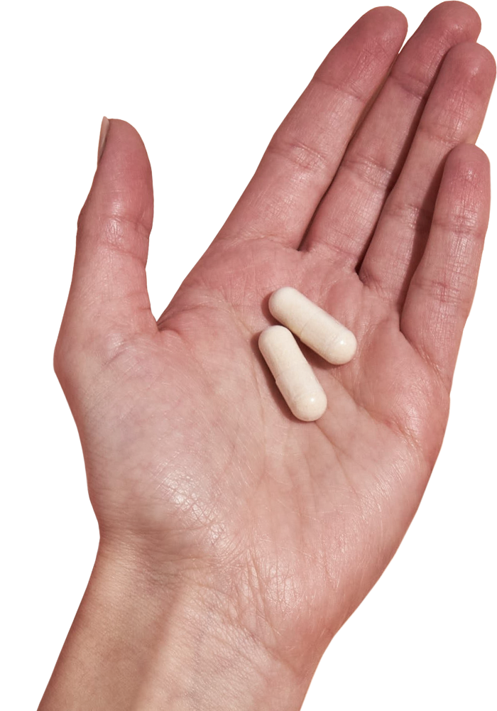 image of hand holding 2 Performance Lab® AU Magnesium capsules