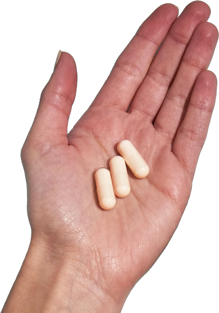 image of hand holding 3 Performance Lab® AU Magnesium capsules